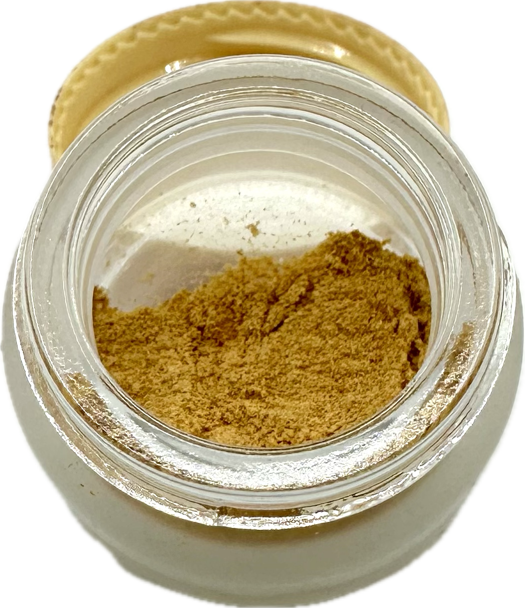 Small opaque glass 1g jar with clear top edge containing tannish orange Kanna Full Spectrum Extract Powder leaning on tan lid. 
Product: Kanna Full Spectrum Extract Powder (1g jar). 
- Kanna's Botanicals LLC